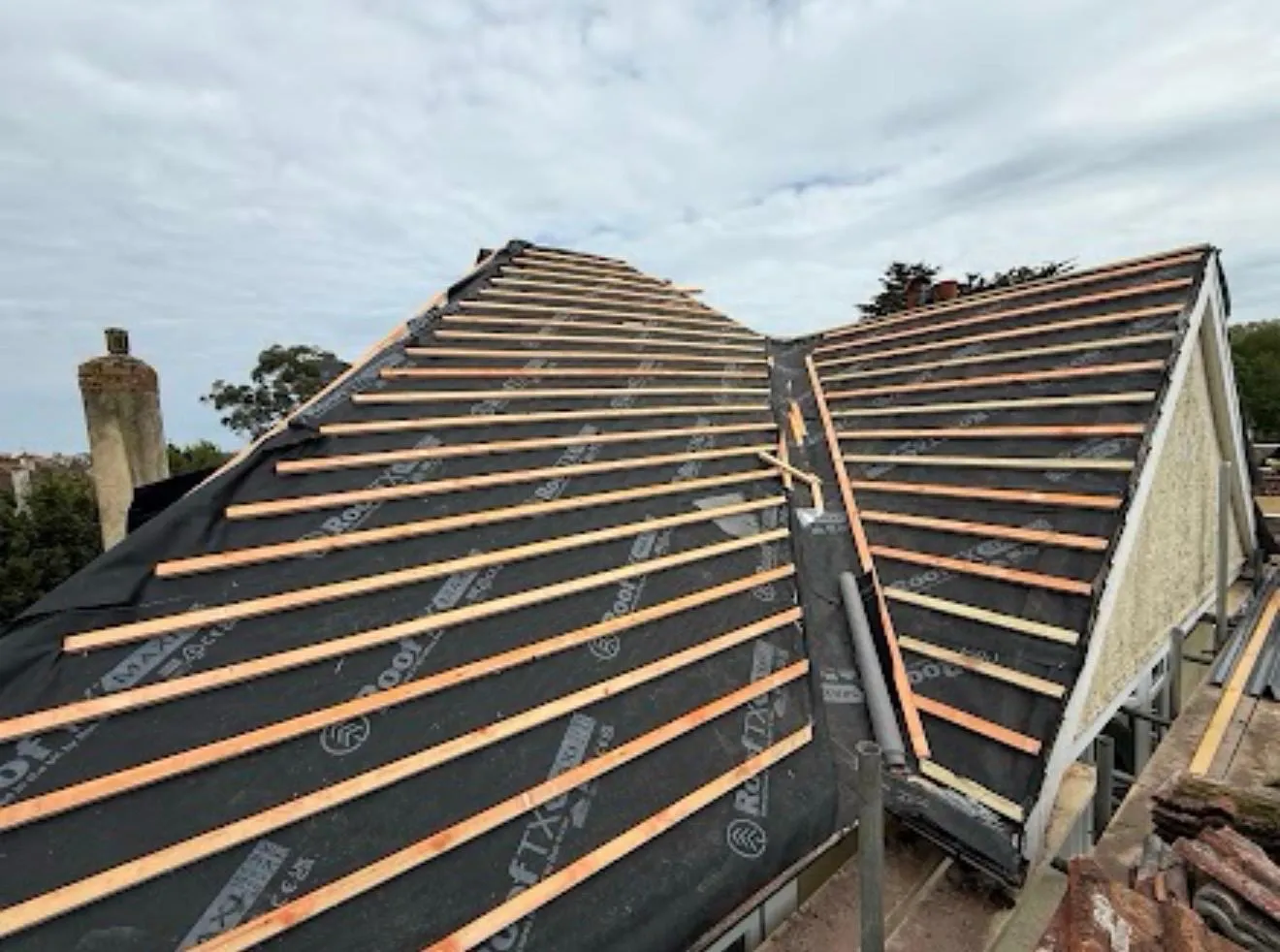 Battens and membrane across two roof slopes that meet at a valley