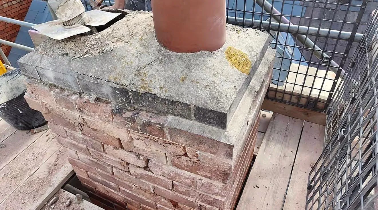 Chimney stack with a single pot and flaunching, with scaffold around it