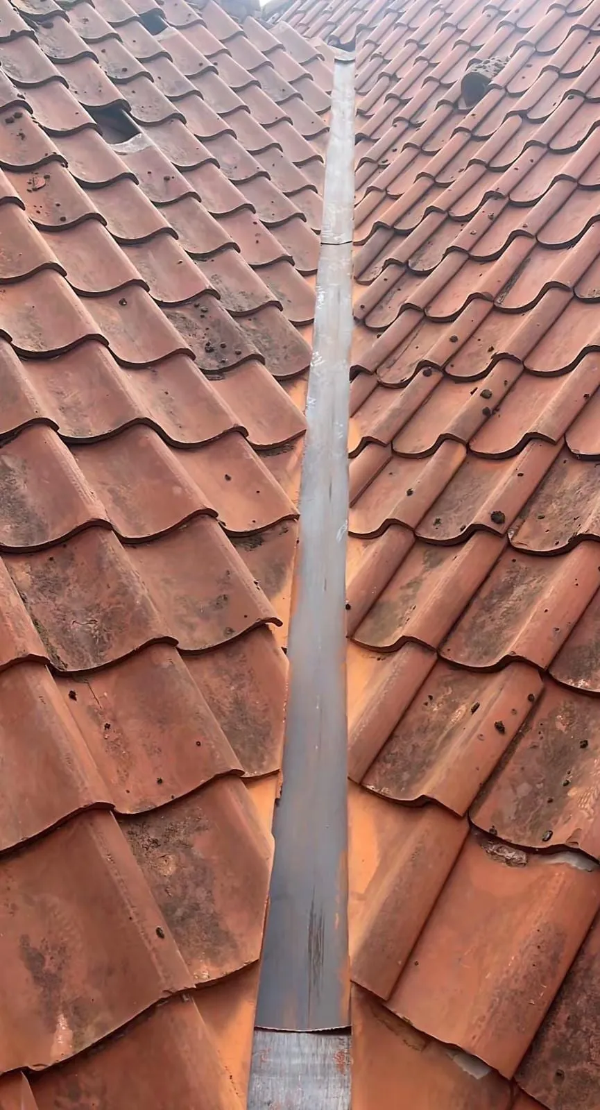Finished lead valley between red tiles