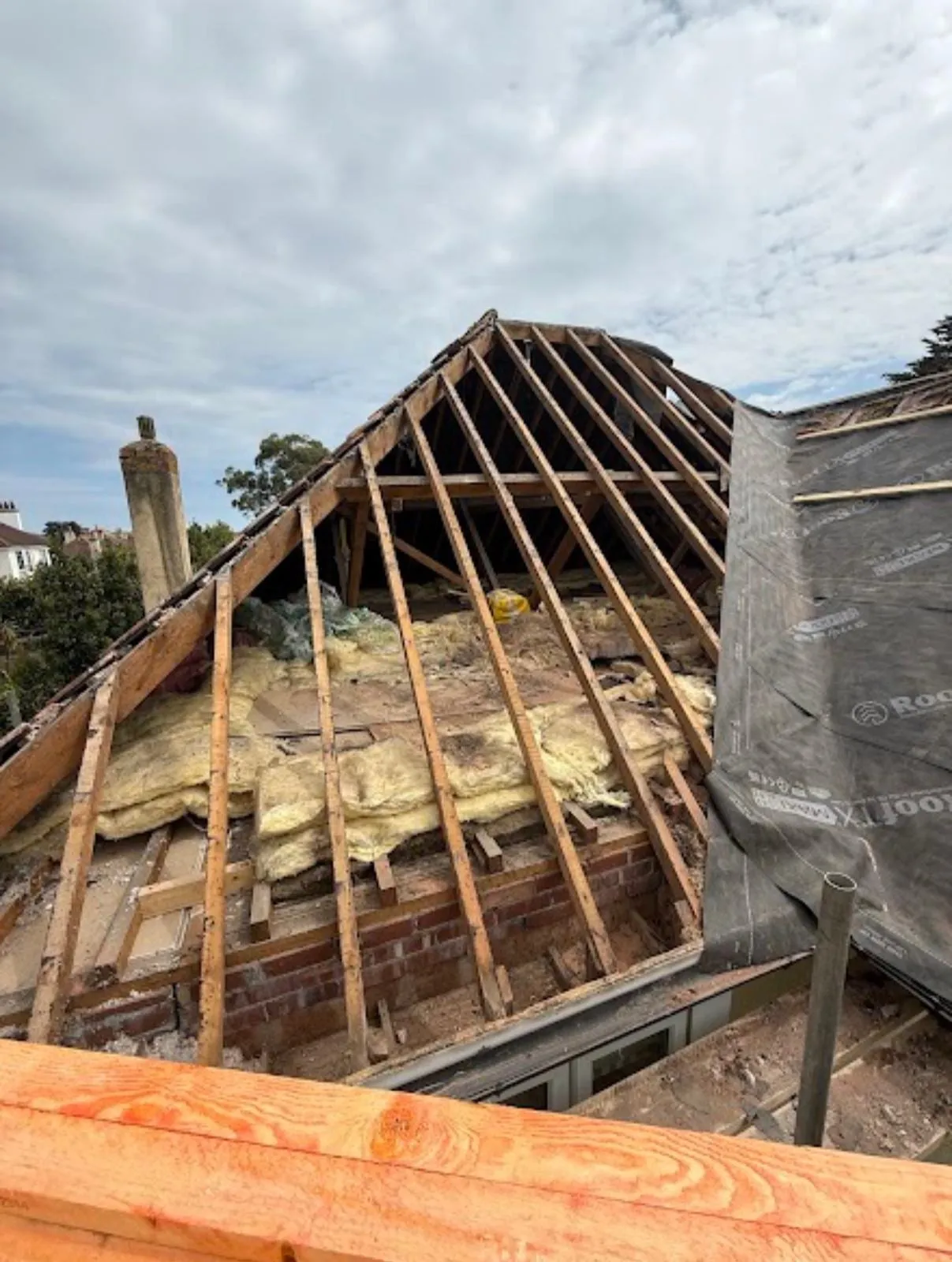 Hipped roof stripped back to the rafters with insulation exposed