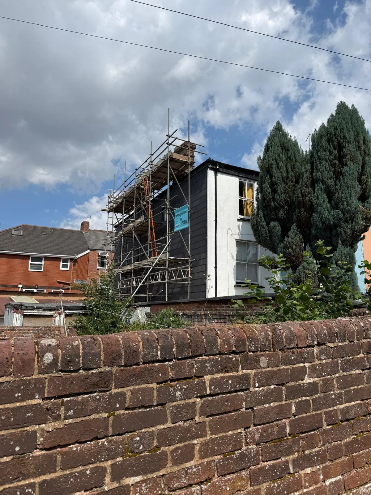 House wrapped in scaffold during a roofing job