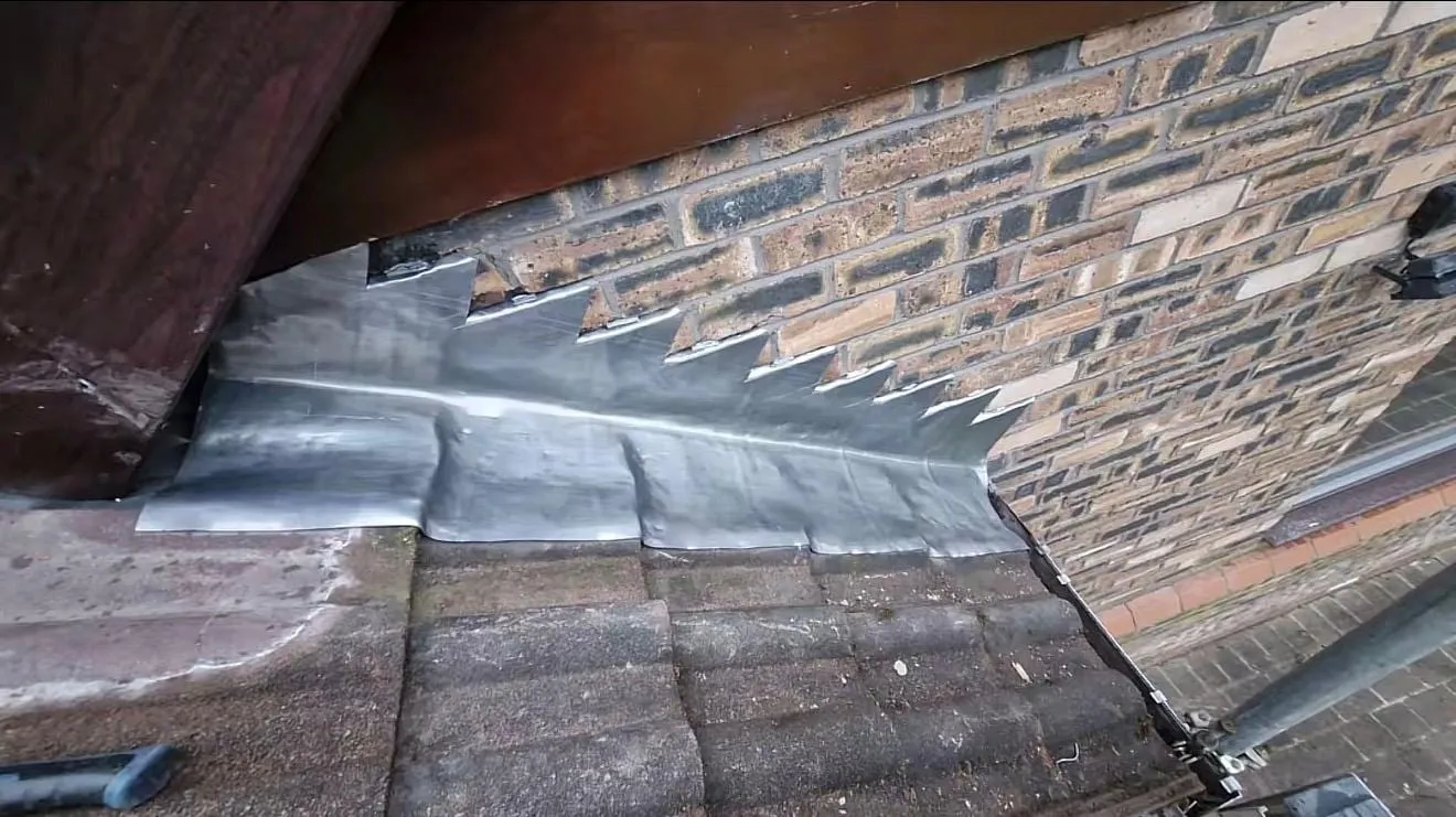 Stepped lead flashing against a brick wall