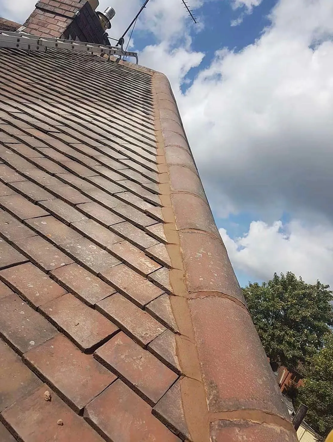 Weathered clay tiles beside a hip line