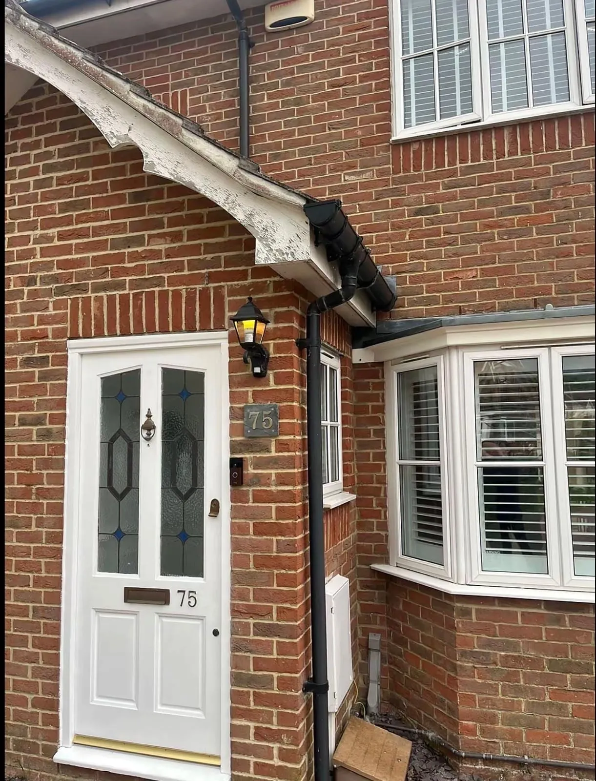 White fascia and bargeboard on a brick house above the front door